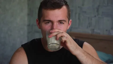 Man drinks milk from a glass Stock Footage 140795641
