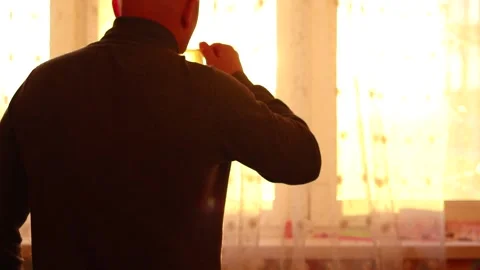 Man drinks morning coffee at the window Stock Footage 150863150