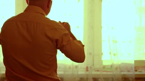 Man drinks morning coffee at the window Stock Footage 150863152