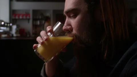 A man drinks orange juice Stock Footage 223881055
