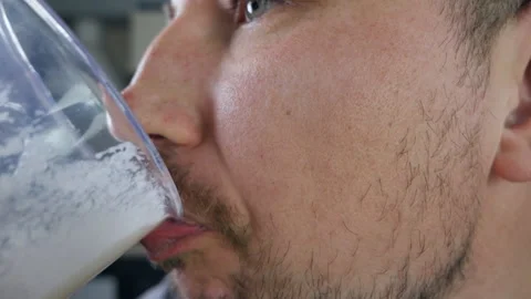 The man drinks the smoothie disgustingly. Vitamin cocktail 스톡 동영상 150059966