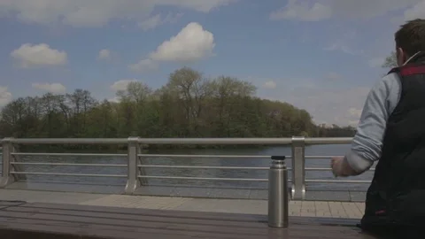 A man drinks tea from a thermos bottle Stock Footage 76940748
