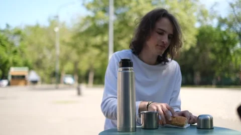 A man drinks tea from a thermos Stock Footage 278862268