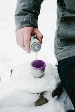 Man drinks tea from a thermos Stock Photos