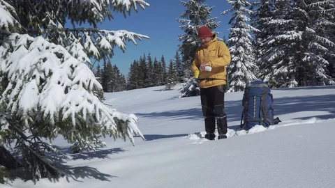 A man drinks tea in winter in a winter forest Stock Footage 127493162