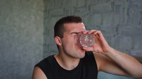 Man drinks vodka sitting alone at home Stock Footage 141356779