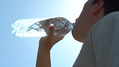 Man drinks water from a plastic bottle. Video stock 158556118