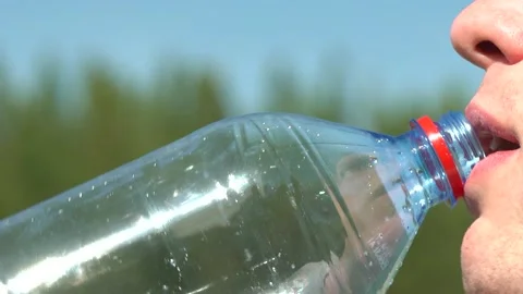 Man drinks water from a plastic bottle. Video stock 162313401