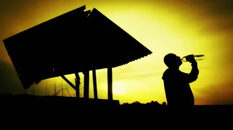 Man drinks water at sunset. Stock Footage 49930857