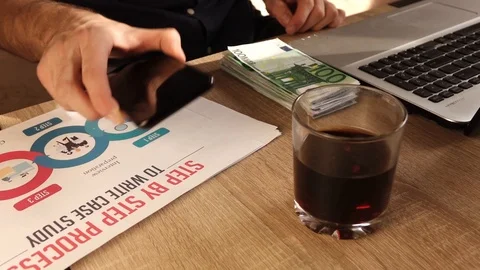 A man drinks whiskey in the workplace Stock Footage 118957226