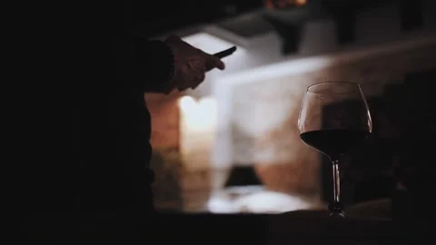 A man drinks wine and uses the phone Stock Footage 165172717