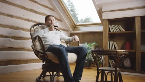 Man drinks wine on the attic Stock Footage 100349195