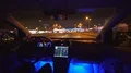 The man drive a car on the city highway. evening night time. wide angle 4k or 4k+ Resolution