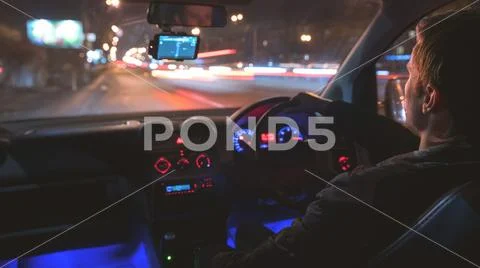 The man drive a car in the city. Inside view. Evening night time Stock Photos