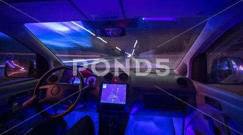 The man drive a car with a gps in the city. Evening night time. Wide angle Stock Photos