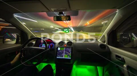 The man drive a car with gps in the night city. Wide angle. Inside view Stock Photos