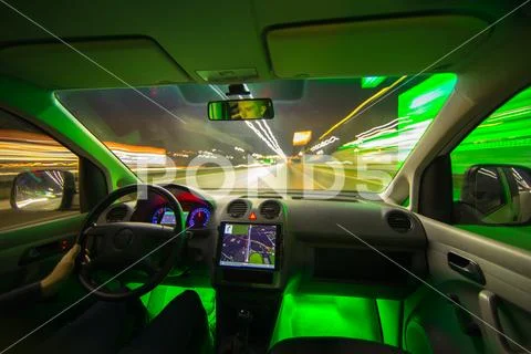 The man drive a car with gps in the night city. Wide angle. Inside view Stock Photos