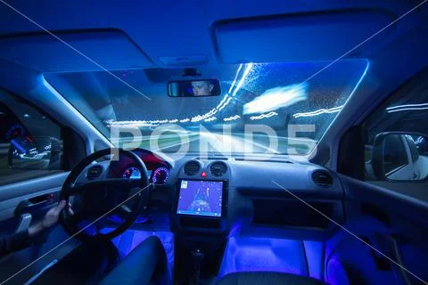 The man drive a car with gps in the night city. Wide angle Stock Photos