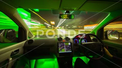The man drive a car in the night city. Wide angle. Left side traffic Stock Photos
