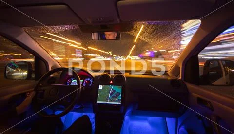 The man drive car in the night city. Inside view. Wide angle Stock Photos