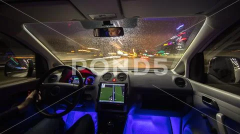 The man drive car in the rainy city. Evening night time Stock Photos