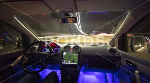 The man drive in the city highway with navigation. Evening night time Stock Photos