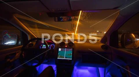 The man drive with a gps on the night city. Inside view Stock Photos