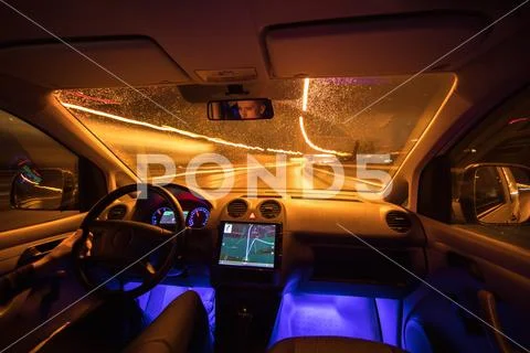 The man drive with a gps on the night road. Inside view. Wide angle Stock Photos