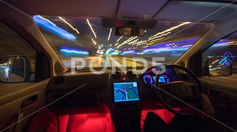 The man drive on the highway. Evening night time. Left side traffic Stock Photos