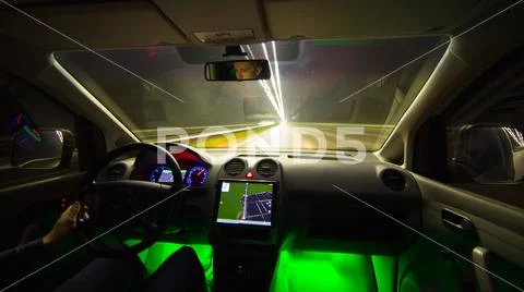 The man drive in the highway with a navigation. Evening night time. Wide angl Stock Photos