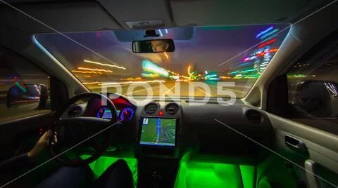 The man drive in the highway with a navigation. Evening night time. Inside vi Stock Photos
