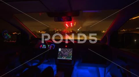 The man drive with a map on the rainy highway. Evening night time. Inside vie Stock Photos