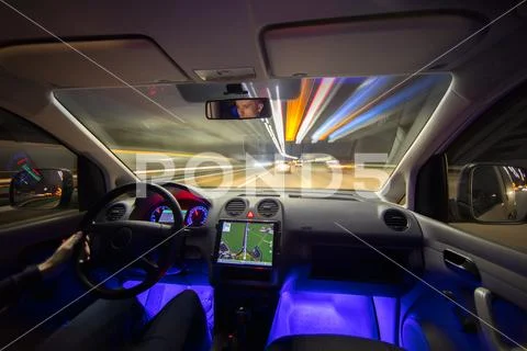 The man drive with navigation in the city highway. Evening night time Stock Photos