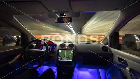 The man drive with a navigation on the highway. Inside view. Evening night ti Stock Photos
