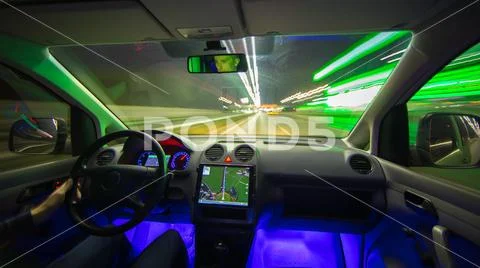 The man drive with a navigation on the highway. Inside view. Evening night ti Stock Photos