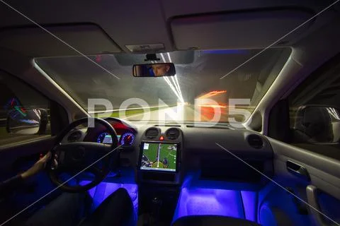 The man drive with a navigation on the highway. Inside view. Evening night ti Stock Photos