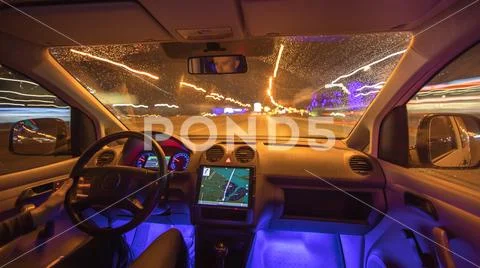 The man drive with navigation in the night city. Inside view. Inside view Stock Photos