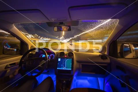 The man drive with a navigation on the night highway. Inside view Stock Photos