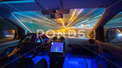 The man drive with a navigation on the rain highway. Inside view Stock Photos