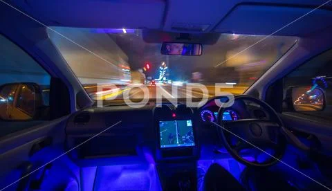 The man drive on the night road. Left side traffic. Wide angle Stock Photos