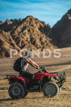 The man drive a quad bike in the desert Stock Photos