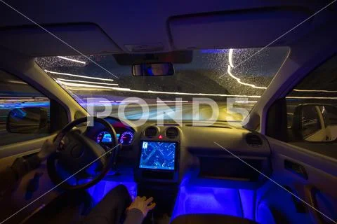 The man drive on the rain highway. Evening night time. Inside view Stock Photos
