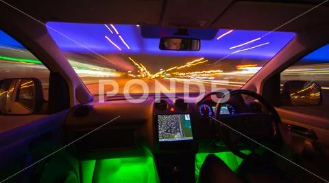 The man drive in a road with a navigation. Evening night time. Left side tr.. Stock Photos