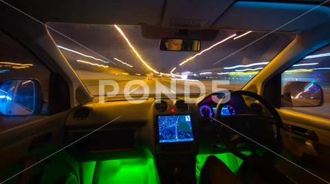 The man drive in a road with a navigation. Evening night time. Left side tr.. Stock Photos