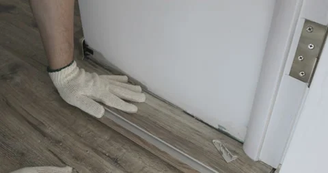 Man drive the screws into the floor Video stock 105836597