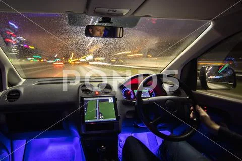 The man drive vehicle in the city highway. Left side traffic. Evening night.. Stock Photos
