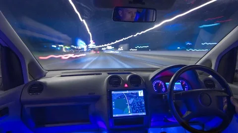 The man drive a vehicle with the gps. Night time. Hyperlapse Stock Footage