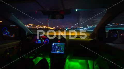 The man drive a vehicle on the night highway. Inside view. Wide angle Stock Photos
