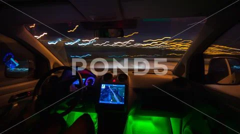 The man drive a vehicle on the night highway. Inside view. Wide angle Stock Photos