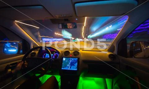 The man drive a vehicle on the night road. Inside view. Wide angle Stock Photos